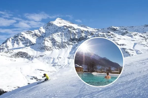 Sciare su una montagna innevata con una vista di una piscina all'aperto in un paesaggio invernale.